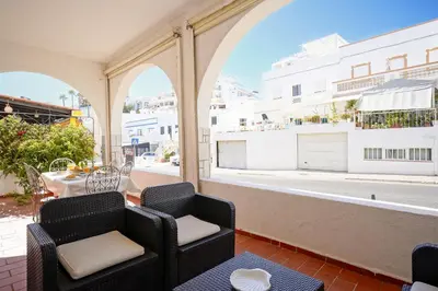 a balcony with two chairs and a table and a building at #341 Casa da Guida 44 by Home Holidays in Olhos de Água