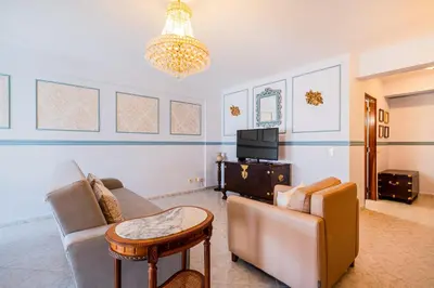 a living room with a couch and a table and a tv at Apartment Solera in Albufeira