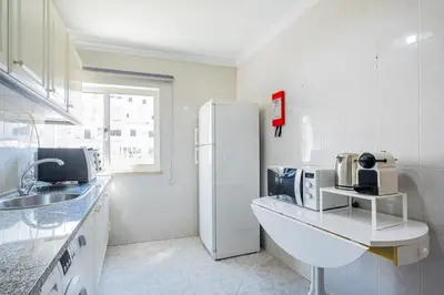 a kitchen with a white refrigerator and a sink at Apartment Solera in Albufeira