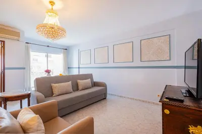 a living room with a couch and a tv at Apartment Solera in Albufeira