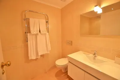 a bathroom with a toilet and a sink and a mirror at Apartamento Mariana, Quinta do Lago