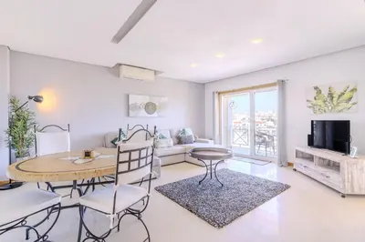 a living room with a table and chairs and a couch at #340 Old Town Garden Hill Z by Home Holidays in Albufeira