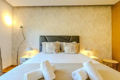 a bedroom with a large bed with white sheets and pillows at #340 Old Town Garden Hill Z by Home Holidays in Albufeira