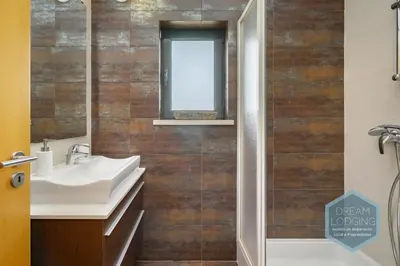 a bathroom with two sinks and a shower at Quinta do Pinheiro Residence AF - Dream Lodging in Albufeira