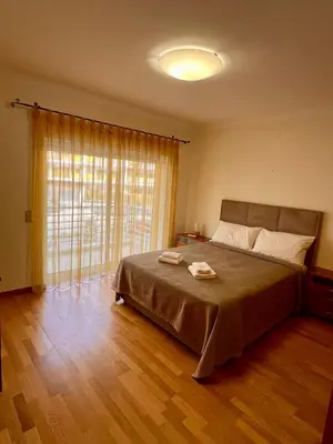 a bedroom with a large bed and a large window at Vilamoura apartment in Quarteira