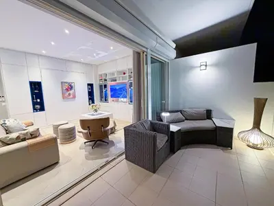 a kitchen with a table and chairs with fruit on it at Serenity by the Ocean Penthouse by BeCherish in Páteo