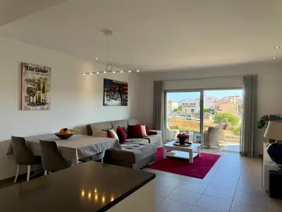 a living room with a couch and a table at Gabbiana apartment Albufeira terrace BBQ and pool in Albufeira
