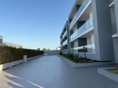 an empty walkway next to a apartment building at Gabbiana apartment Albufeira terrace BBQ and pool in Albufeira