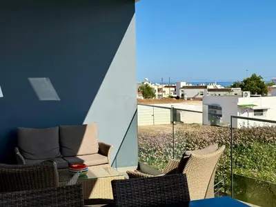 a balcony with wicker chairs and a couch at Gabbiana apartment Albufeira terrace BBQ and pool in Albufeira