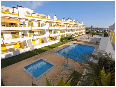 an aerial view of a building with two swimming pools at Apartamentos Capitolina in Quarteira