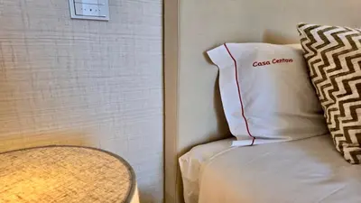 a pillow sitting on a bed next to a wall at Casa Centavo - Natura Village, CD 317 - Cleverdetails in Quarteira