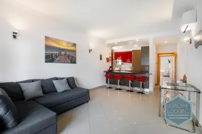 a living room with a couch and a kitchen at Pinheiro Residence - Dream Lodging in Albufeira