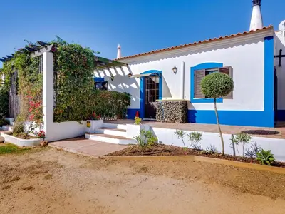 a house with a blue and white at Vivenda Pereiras com 2 quartos em Quarteira in Quarteira