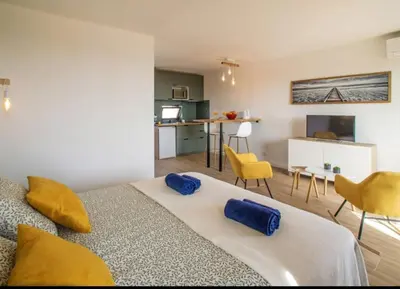 a bedroom with a bed and a living room at Sea view studio, terrace & pools - Albufeira in Albufeira
