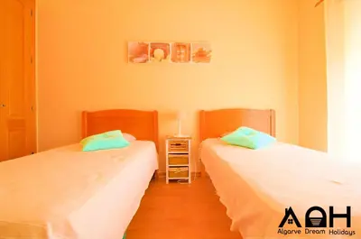 two beds sitting next to each other in a room at Sunny Terrace facing the pool and barbecue by Algarve Dream Holidays in Guia