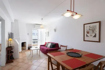 a living room with a table and a couch at Cozy 2BR Apartment in Albufeira with Balcony, by Hopstays in Albufeira