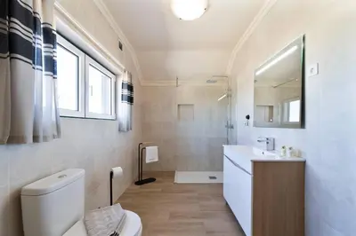 a bathroom with a toilet and a sink at Vivenda Lemos A in Albufeira