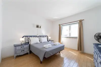 a bedroom with a bed and a window at Vivenda Lemos B in Albufeira