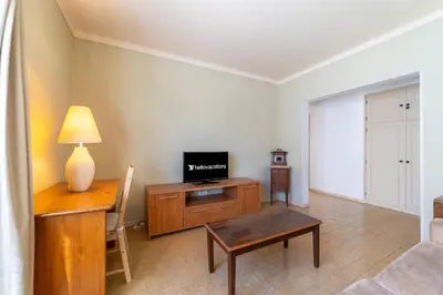 a living room with a desk and a tv on a table at Vivenda Lemos B in Albufeira