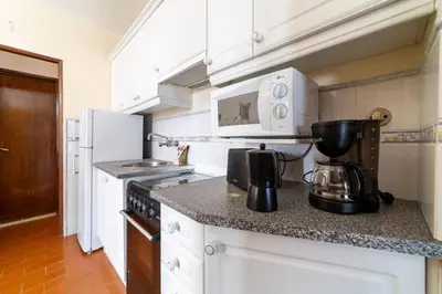 a kitchen with a coffee maker on a counter at Vivenda Lemos D in Albufeira