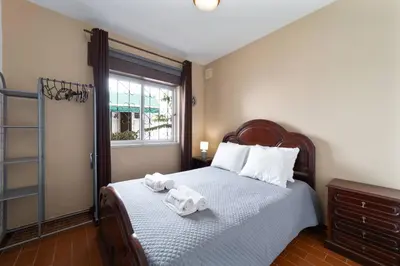 a bedroom with a bed with two towels on it at Vivenda Lemos D in Albufeira