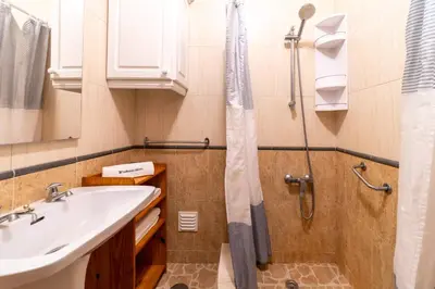 a bathroom with a sink and a shower at Vivenda Lemos D in Albufeira