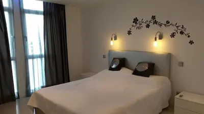 a bedroom with a bed with two pillows on it at Bay View Apartments in Albufeira