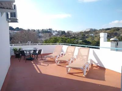 a group of chairs and a table on a balcony at Bay View Apartments in Albufeira
