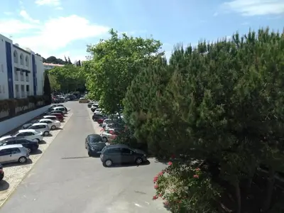 a row of cars parked in a parking lot at Bay View Apartments in Albufeira