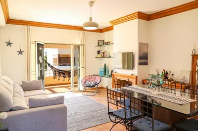 a living room with a couch and a table at Atlântida Golf Village by Garvetur in Quarteira