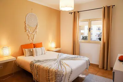 a bedroom with a bed and a window at Atlântida Golf Village by Garvetur in Quarteira