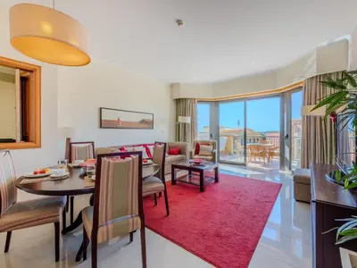 a living room with a table and a dining room at Apartment The Residence at Victoria by Interhome in Vilamoura