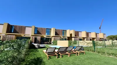 a group of chairs sitting in the grass in front of a building at Casa Bougainvillea by CleverDetails, private pool 