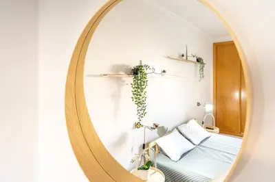 a mirror in a bedroom with a bed at Falésia Beach I by HelloVacations in Albufeira