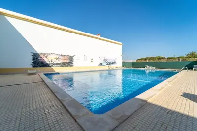 a swimming pool on the side of a building at Falésia Beach I by HelloVacations in Albufeira