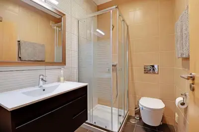 a bathroom with a shower and a sink and a toilet at Jardins da Marina by Albufeira Rental in Albufeira
