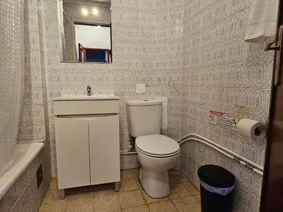 a bathroom with a toilet and a sink and a mirror at Blife Olindya private rooms in Faro