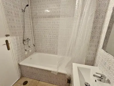 a bathroom with a shower and a tub and a sink at Blife Olindya private rooms in Faro