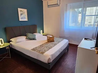 a bedroom with a bed with a bag on it at Blife Olindya private rooms in Faro