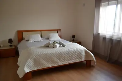 a bedroom with a bed with two stuffed animals on it at Magnifique Villa à 10min de la mer in Faro