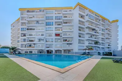a large apartment building with a swimming pool in front of it at Alexandra Paradise in Albufeira