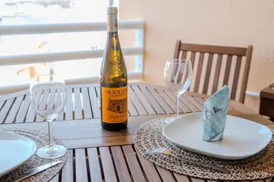 a bottle of wine sitting on a table with two glasses at Algarve Vilamoura Quarteira vue sur Ocean-Portugal in Quarteira