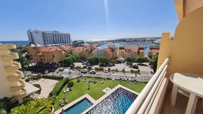 a view from the balcony of a building with a pool at Algarve Vilamoura Quarteira vue sur Ocean-Portugal in Quarteira