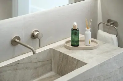 a bathroom sink with a bottle of soap and toothbrushes at Townhouse with Heated Pool in Downtown Faro in Faro