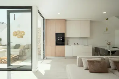 a living room with a couch and a kitchen at Townhouse with Heated Pool in Downtown Faro in Faro
