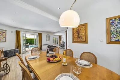 a dining room with a table with a bowl of fruit on it at Villa Medicis by Villa Plus in Albufeira