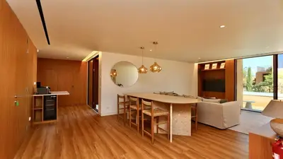 a kitchen and living room with a table and chairs at Villa Harmony - Natura Village by Cleverdetails in Quarteira