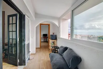 a living room with a couch and a table at Maison Jack in Albufeira