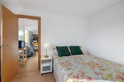 a bedroom with a bed and a desk and a television at Maison Jack in Albufeira