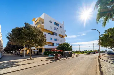 a building on the side of a street at Sol & Mar Quarteira in Quarteira
